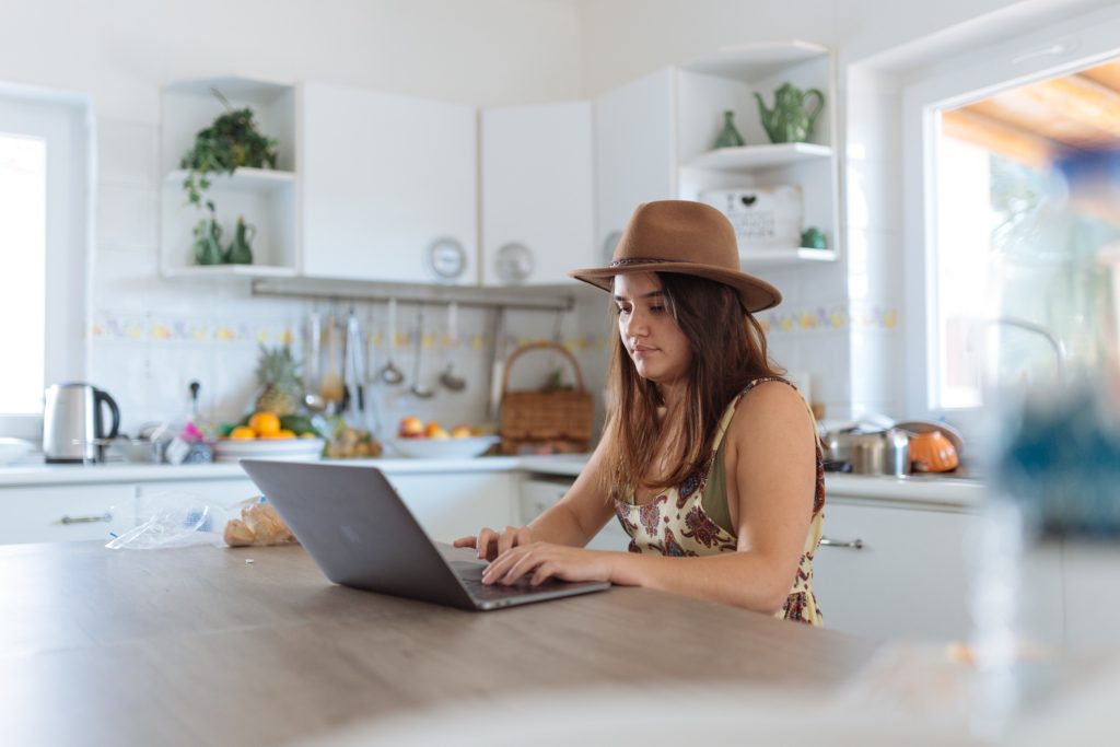 girl working in kitchen on laptop