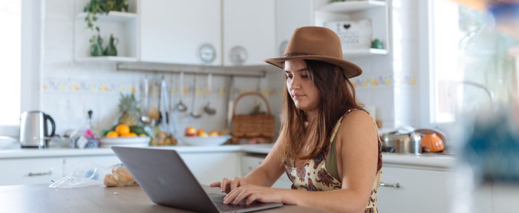 girl working in kitchen on laptop